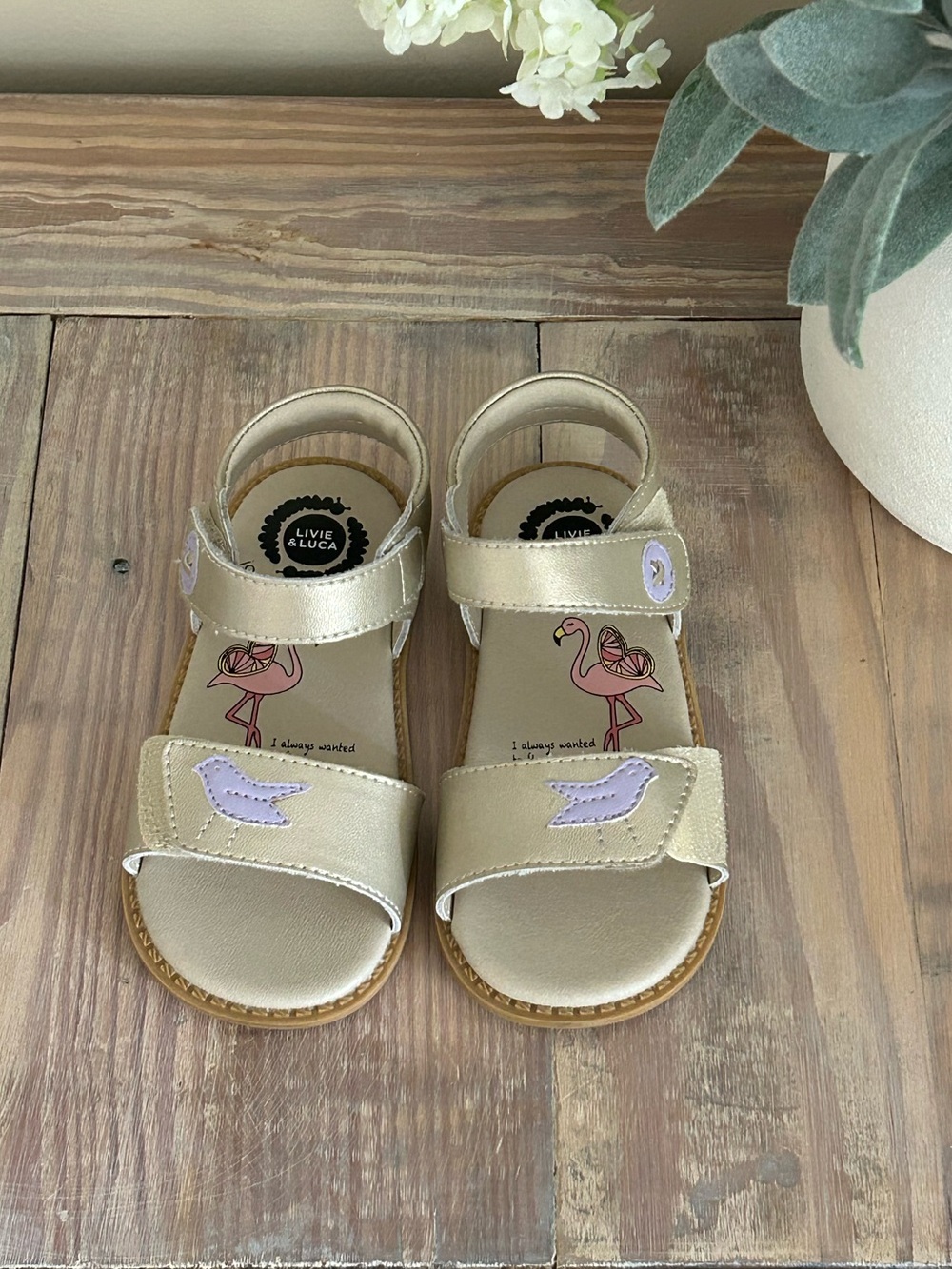 Livie & Luca Metallic Champagne Sandals with Lilac Bird Appliqué